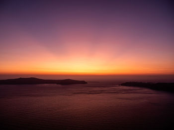 Scenic view of sea against romantic sky at sunset