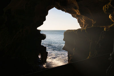 Scenic view of sea seen through cave