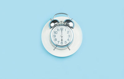 Close-up of clock against blue background