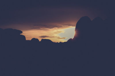 Silhouette of man against cloudy sky