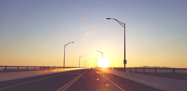Driving into the sun on a bridge