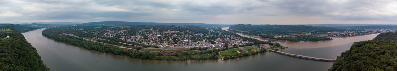 High angle view of river amidst cityscape against sky