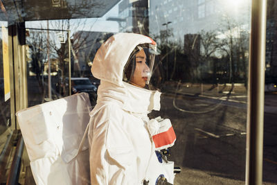 Man looking through glass window