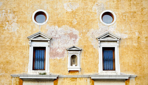 Windows on decay wall building architecture, venice, italy