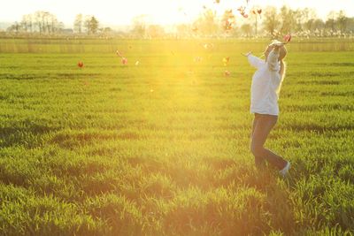 Side view of woman standing in field