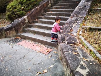 Rear view of cute baby boy on staircase