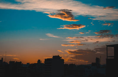 Silhouette buildings against sky during sunset