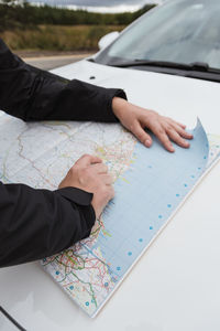 High angle view of man legs on car