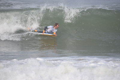 People surfing in sea