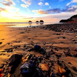 Scenic view of beach against sky during sunset