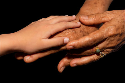 Close-up of hands over black background