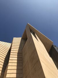 Low angle view of building against blue sky