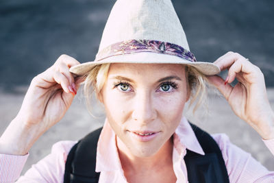 Close-up portrait of woman wearing hat outdoors