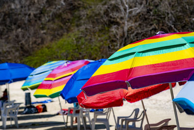 Close-up of multi colored umbrellas on beach