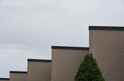 Low angle view of factory against sky