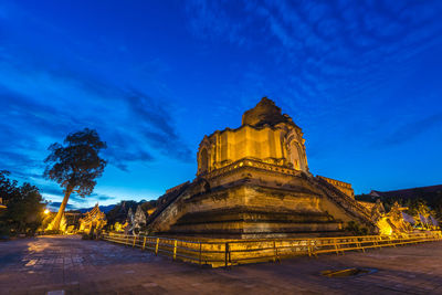Temple against blue sky at night