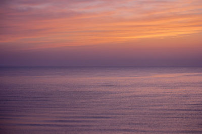 Scenic view of sea against romantic sky at sunset