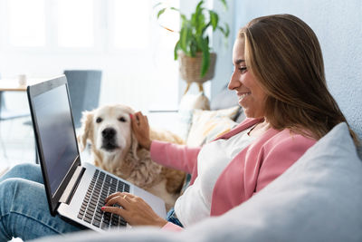 Rear view of woman using laptop