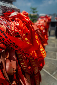 Close-up of red bell hanging in temple