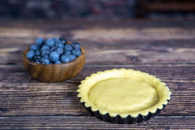 Delicious blue berry tart dough or pie on wood table background.