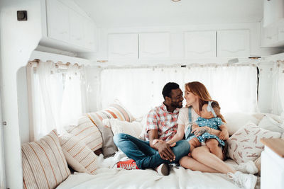 Cheerful family siting in camper van