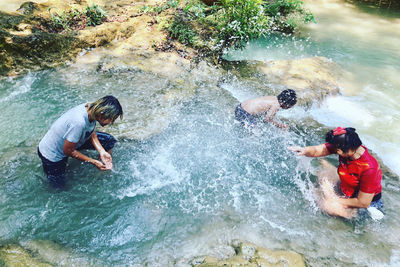 High angle view of people enjoying in sea