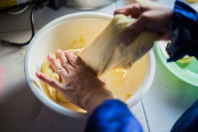 Cropped hands of woman preparing food in kitchen