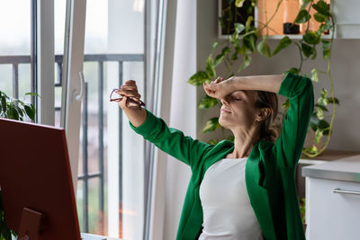 Young woman enjoys resting after hard work on future business project in cozy room. overwork.