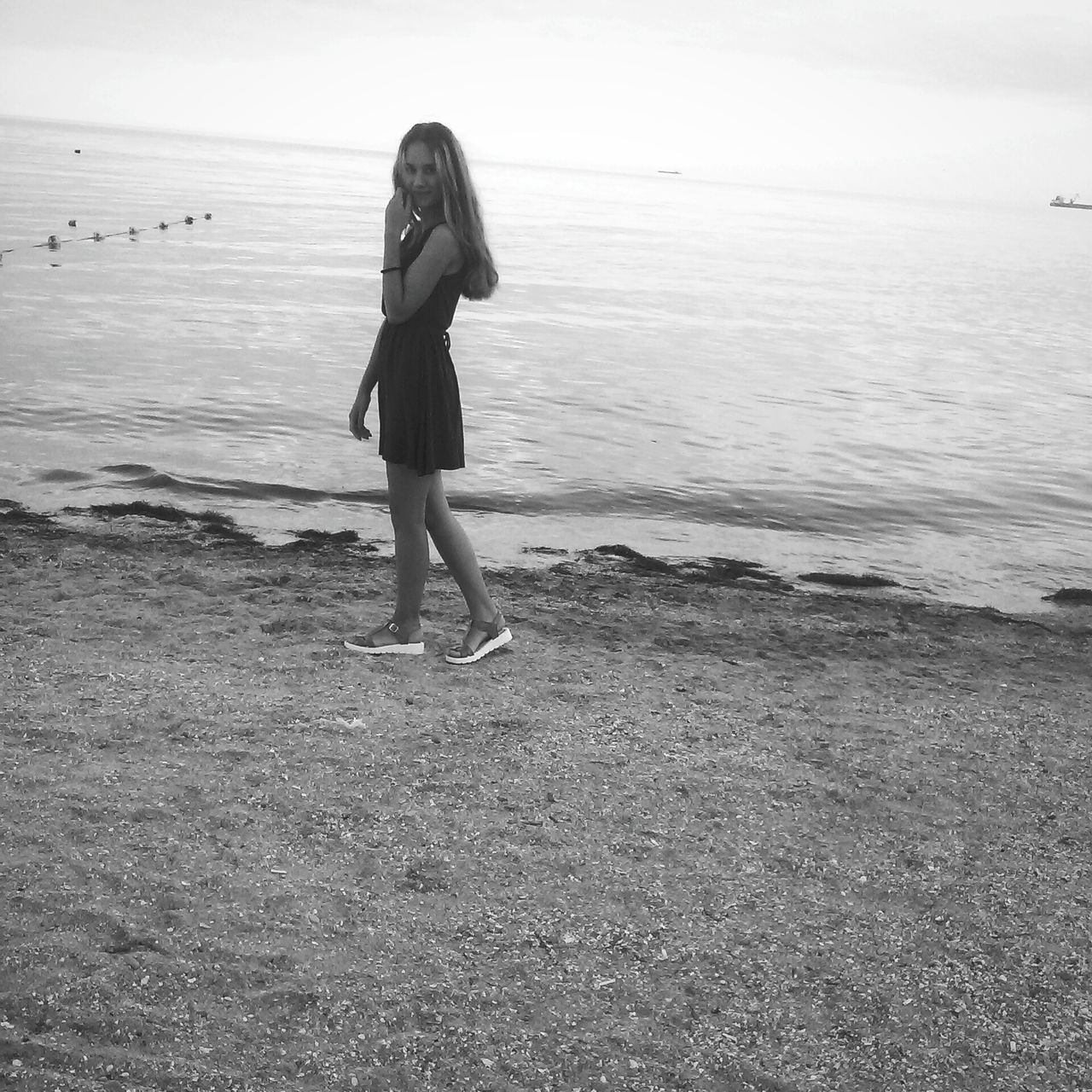 beach, sea, sand, shore, full length, lifestyles, leisure activity, water, rear view, horizon over water, tranquility, childhood, standing, tranquil scene, casual clothing, walking, nature, sky