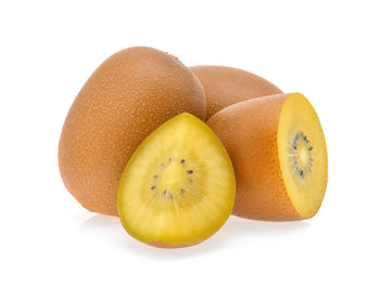 Close-up of kiwi fruits against white background