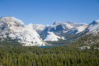 Scenic view of snowcapped mountains against clear blue sky