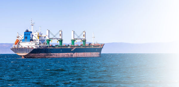 Bulk cargo ship to harbor quayside vladivostok in soft sunlight