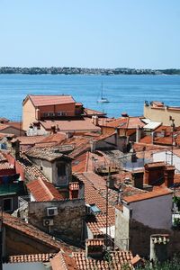 Townscape by sea against clear sky