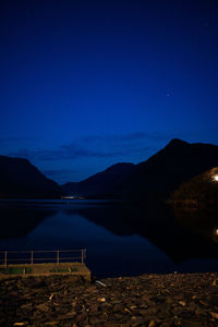 Scenic view of lake against sky at night