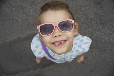 Portrait of gap toothed smiling girl standing outdoors