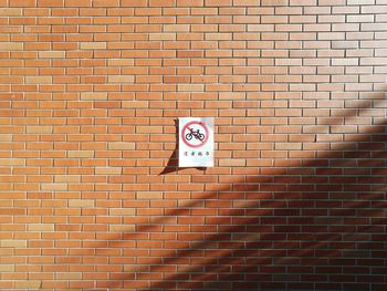 No cycling sign on brick wall on during sunny day