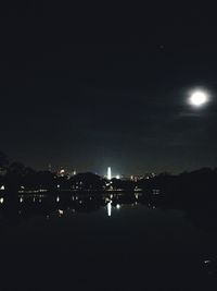 Illuminated city against sky at night