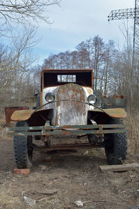 Abandoned truck on railroad track against sky