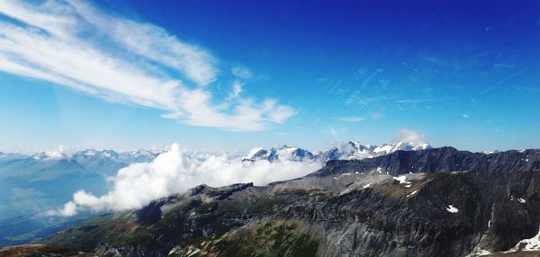 Scenic view of mountains against blue sky