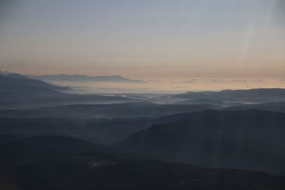 Scenic view of silhouette mountains against sky during sunset