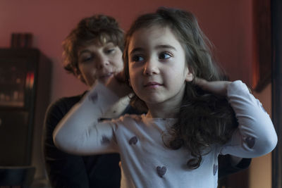 Portrait of mother and daughter at home