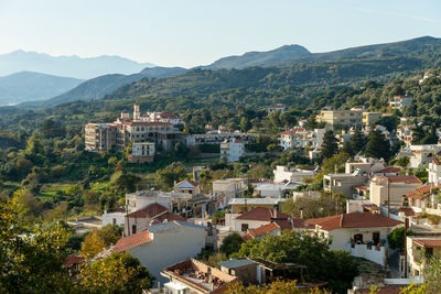 High angle view of townscape and mountains against clear sky