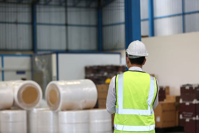 Rear view of man working in factory