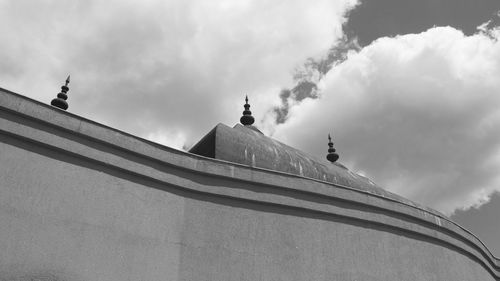 Low angle view of statue of temple against cloudy sky