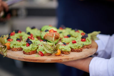 Toasted bread canapes with marzipan and avocado fruits and spices