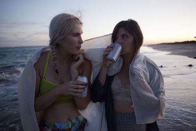 Friends drinking on a beach