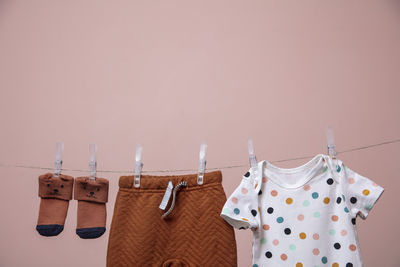 Close-up of clothes drying on clothesline against wall