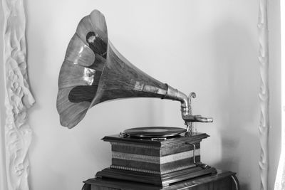 Gramophone by wall on table at home