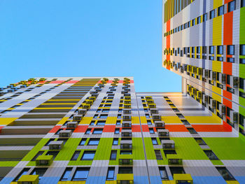 Low angle view of modern building against clear blue sky