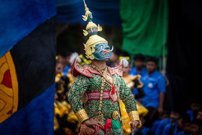 Man in traditional clothing while standing on street during event